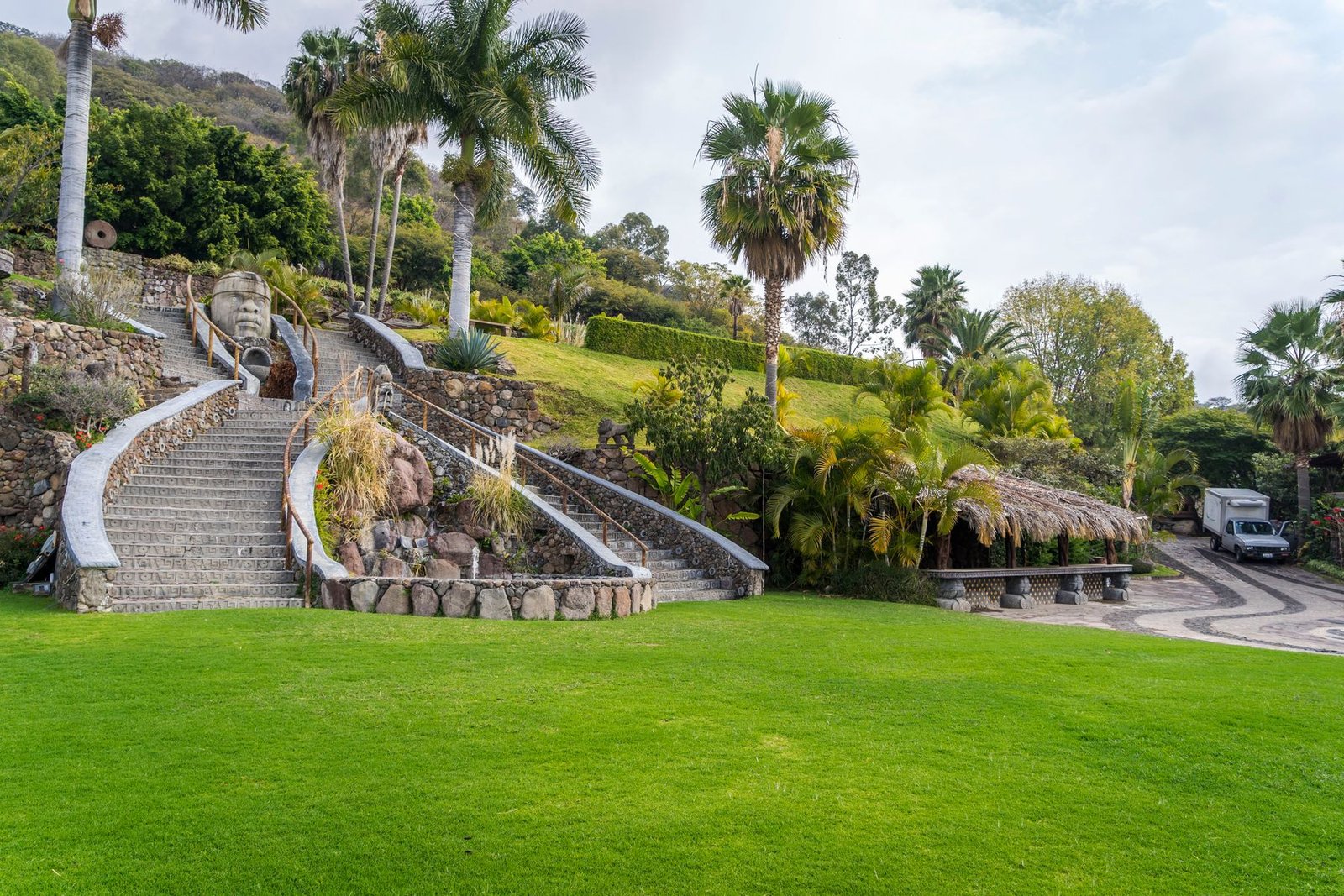 Backyard landscape design featuring stone steps and tropical plantings