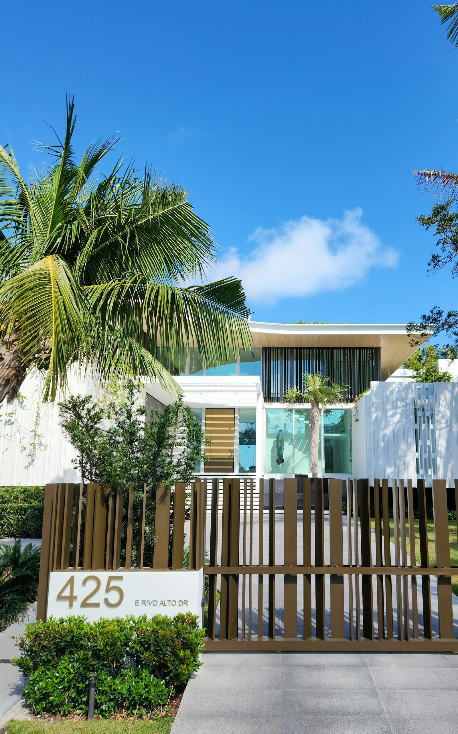 Well-maintained Florida home with manicured front yard and palm trees for curb appeal